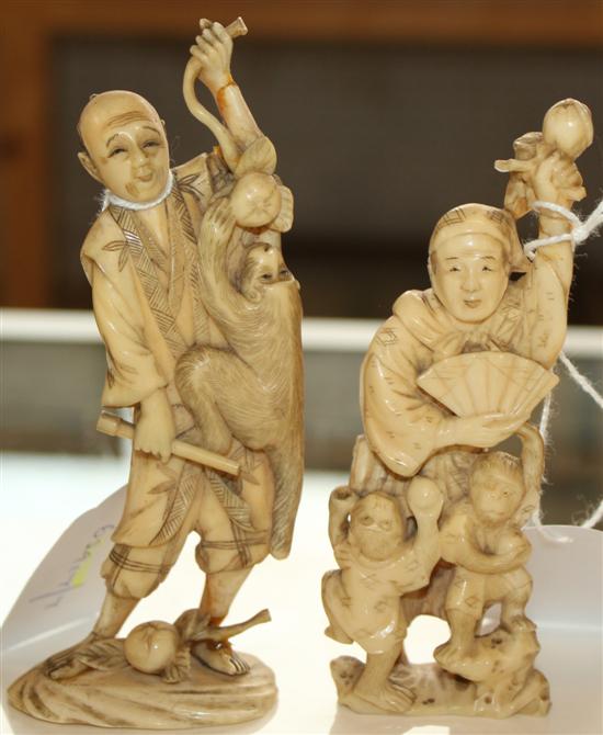 2 Japanese Meiji carved ivory okimonos of monkey trainers, both with paper labels to bases (one a.f)